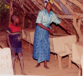 A honey farmer demostrating how she harvests beess honey