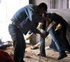 Photo:  LHA volunteers cleaning a flooded home in Um an Naser in Gaza.
