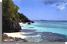 Photo - View of a rocky coast with turquois blue waters.