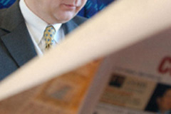 Man reading a newspaper © EC