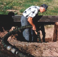 Picture of man pumping septic system