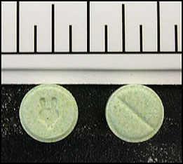 photo of 10 green tablets with an unidentified logo (possibly an animal head)