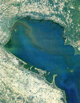 This aerial photograph depicts a massive plume of sediment that emanates from the mouth of the Saginaw River and traverses through Saginaw Bay