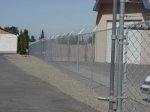 image View of new fence between Voorhies and Boomsnub, graded areas of V-1, B-12,  B-12a, and new asphalt in front of treatment building.  