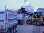 image clean-up workers loading trucks with contaminated soil for off-site disposal