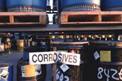 Photo of drums containing corrosive wastes.