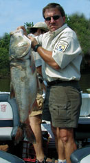 Photo of man holding large Asian carp