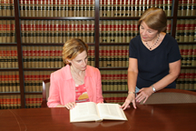 photo of OGC attorney discussing legal research question with law librarian