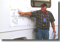 A Radiological Emergency Response Team Commander briefs responders on their organizational roles during an exercise, using the Incident Command System.