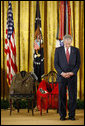 President George W. Bush bows his head during a prayer Monday, March 3, 2008 in the East Room of the White House, standing before two chairs in honor of U.S. Army Master Sgt. Woodrow Wilson Keeble, left, and his wife, Bloosom, moments before presenting members of the Keeble family with the Medal of Honor, posthumously, in honor of Master Sgt. Keeble’s gallantry during his service in the Korean War. Keeble is the first full-blooded Sioux Indian to receive the Medal of Honor. White House photo by Eric Draper