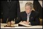 President George W. Bush signs the condolence book at the Egyptian Embassy, Monday, July 25. 2005 in Washington, expressing heart-felt sympathies for those who have lost their lives and were injured in the terror bombing in Sharm el-Sheikh, Egypt.  White House photo by Eric Draper