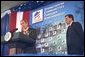 As Secretary Mel Martinez listens, President George W. Bush discusses home ownership at the Department of Housing and Urban Development Tuesday, June 18.  