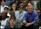 President George W. Bush, Laura Bush and Washington Redskins star Darrell Green (seated in front of Mrs. Bush) watch the tee ball action on the South Lawn Sunday, June 22, 2003. Mr. Green is the Chairman of the President's Council on Service and Civic Participation and during the game recognized Tanisha Faulkner and Mileika Miki of Fort Meade 4-H for their volunteer service.  White House photo by Lynden Steele