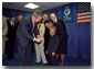 After presenting President George Bush with a pair of boots, March of Dimes Ambassador Justin Lamar Washington gives the President a dollar to help with contributions to the Afghan children during the organizations' Washington D. C. event Oct. 12. White House photo by Tina Hager.