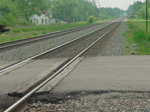 Photo of rail tracks and a road crossing in Owen. (2002)]