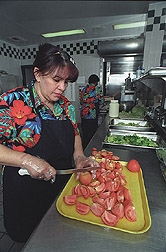 Food service workers prepare meals for the school lunch program: Click here for full photo caption.