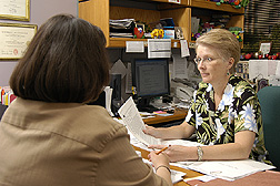 A behavioral nutritionist reviews intervention materials with staff: Click here for full photo caption.
