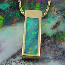 image of an gold encased opal stone on a gold chain