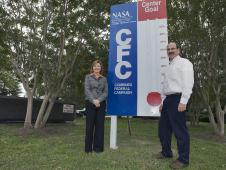 Langley Director Lesa Roe (L) and CFC Chair George Finelli stand beside a CFC goal marker