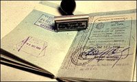 Open passport and a passport stamp.