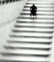 Man going up the stairs in a wheelchair.
