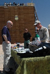 A Border Patrol Agent shows Secretary Chertoff items Border Patrol members carry on rescue missions before a training exercise. (DHS Photo/Bahler)
