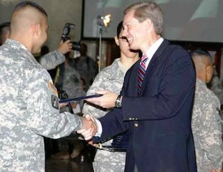 Acting USCIS Director Scharfen welcomes new citizen during naturalization ceremony in Iraq. (Photo USCIS)