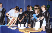 The Girl Scouts prepare for a hands-on exercise involving various inks.