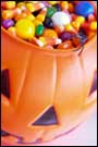 Halloween candy fills a plastic jack o'lantern