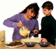 A Woman Cooking with a Boy