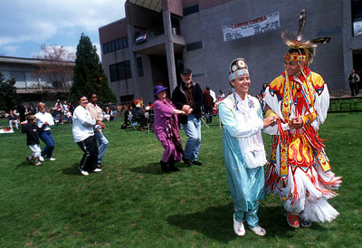 Native American students lead a traditional dance during the annual Pow-Pow on Harris Field.