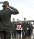 Saluting a flag-draped coffin in a military funeral