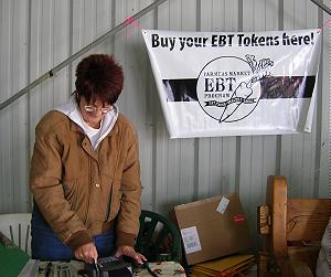 Photo of woman swiping EBT card.