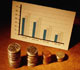 Bar graph with stacks of coins in the foreground