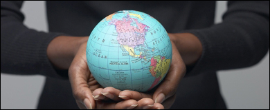 Photo: Hands holding a globe