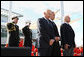 President George W. Bush, joined by former astronauts Edwin 'Buzz' Aldrin, left, and Scott Carpenter, stand together during a moment of silence after tossing a memorial wreath Tuesday, Nov. 11, 2008 from the deck of the USS Intrepid into the Hudson River, during a Veteran's Day tribute in New York. White House photo by Chris Greenberg