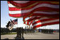 U.S. flags wave in the wind Tuesday, Feb. 26, 2008 during an Uncasing of the Colors Ceremony for the Third Corps at Fort Hood, Texas. White House photo by David Bohrer