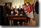 President George W. Bush looks over to Thomas Martello, 6, during the signing ceremony of the Victims of Terrorism Tax Relief Act in the East Room Jan. 23. "We're joined today by families who have lost loved ones in the great acts of evil," said the President. "As you draw on faith and personal strength to cope with your grief, I hope you'll also find comfort in the knowledge that your nation stands with you and prays for you. We mourn those whom we've lost, and we face the future together." White House photo by Eric Draper.