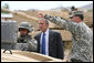 President George W. Bush watches as a soldier operates technical field equipment, joined by U.S. Army Captain Pat Armstrong, right, during President Bush’s visit to the U.S. Army National Training Center Wednesday, April 4, 2007, at Fort Irwin, Calif.  White House photo by Eric Draper