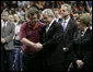 President George W. Bush comforts James Tyger, outgoing Student Government president, Tuesday, April 17, 2007, during the Convocation on the campus of Virginia Tech in Blacksburg, Va. The President and Mrs. Laura Bush attended the service honoring students, faculty and staff who died or were injured in Monday's tragic shooting. White House photo by Eric Draper