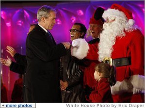 President George W. Bush exchanges knuckles with Santa Thursday, Dec. 4, 2008, during the 2008 Lighting of the National Christmas Tree Ceremony on the Ellipse in Washington, D.C. It is the 85th year of the ceremony that began during the Coolidge Administration. White House photo by Eric Draper