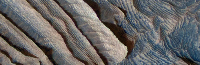 Rhythmic bedding in sedimentary bedrock within Becquerel crater on Mars