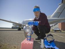 Mike Dobbs pours liquid nitrogen which will cool the laser detector in flight