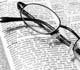eyeglasses sitting on an open dictionary