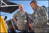 Chief of the National Guard Bureau Gen. Craig McKinley (center) receives a briefing on mobile communications systems from Sgt. Bernard Fuller