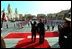 President George W. Bush and Peruvian President Alejandro Toledo (right) wave from the steps of the Presidential Palace in Lima, Peru, March 23, 2002. White House photo by Eric Draper