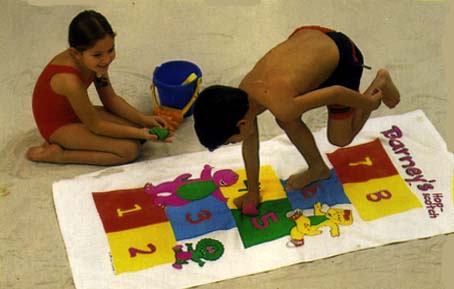 Kids playing Hopscotch  on a Barney Game Towel