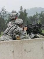 Soldiers fire a machine gun at Fort McCoy