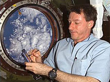 Astronaut Mike Foale in front of a space station window
