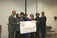 Congressman Jackson and representatives of Metropolitan Family Services displaying a giant check to the for $235,000 for 'Domestic violance services'